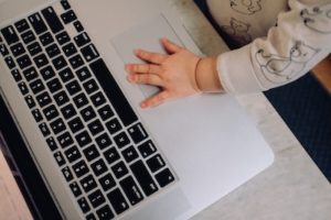 a child's hands using a computer